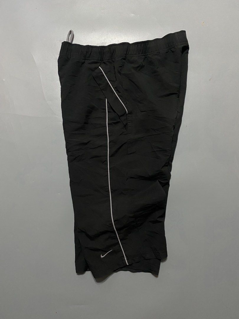 vintage Nike Black Nylon capri (Category: Shorts) located in Manila. Submitted by delunakenn94368 (Listing ID 1467141428, Image 3). Description: - Brand: Nike - Color: Black with white piping and logo - Size: Medium - Material: Lightweight nylon - Features: Elastic waistband with grey drawstring, contrasting front pockets, small embroidered white swoosh - Condition/Details: Clean interior tags, perfect for casual wear or workouts.