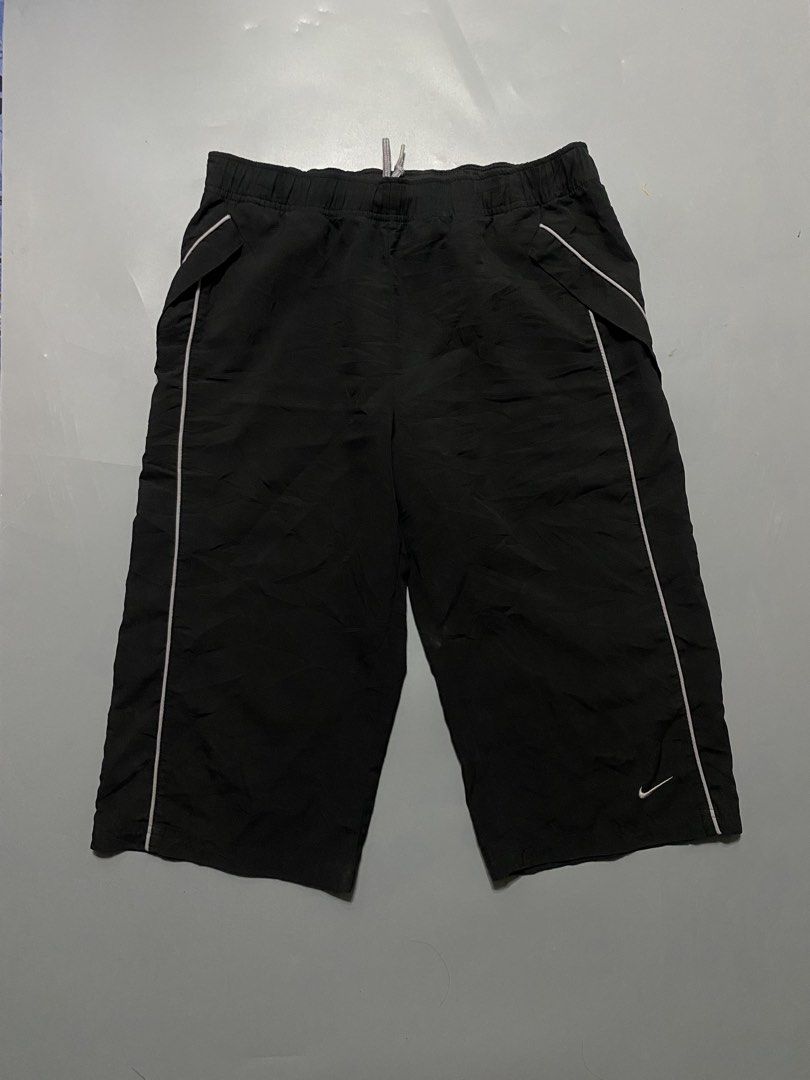 vintage Nike Black Nylon capri (Category: Shorts) located in Manila. Submitted by delunakenn94368 (Listing ID 1467141428, Image 1). Description: - Brand: Nike - Color: Black with white piping and logo - Size: Medium - Material: Lightweight nylon - Features: Elastic waistband with grey drawstring, contrasting front pockets, small embroidered white swoosh - Condition/Details: Clean interior tags, perfect for casual wear or workouts.