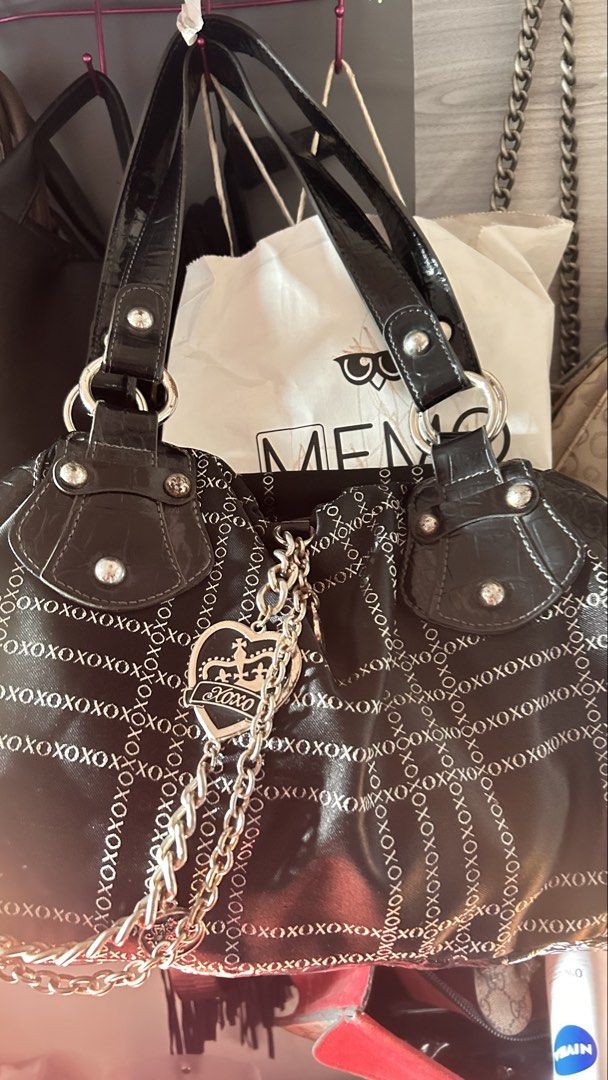 Vintage xoxo shoulder bag (Category: Shoulder Bags) located in Bauang. Submitted by alyssaaaamm (Listing ID 1467058979, Image 2). Description: black faux-leather shoulder bag with a glossy finish, repeating “XOXO” print details, and an ornate silver chain with a heart-shaped charm. Min rust on rings not too visible And minor rust on chains .