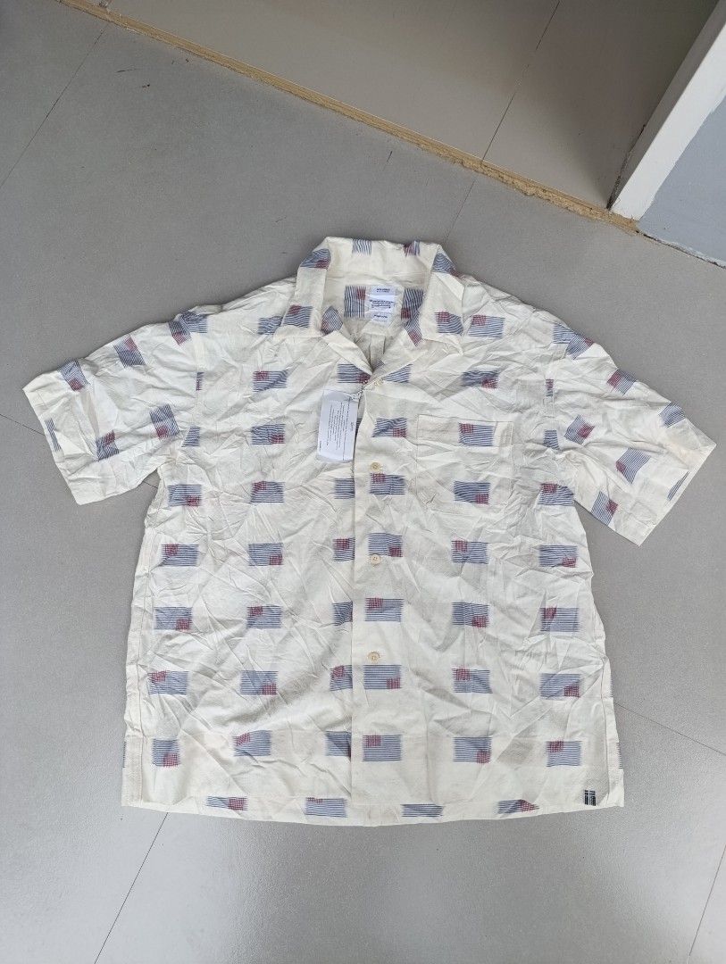 Visvim Short Sleeve Polo (Category: Tshirts & Polo Shirts ) located in Davao. Submitted by idioticthrifter (Listing ID 1467155721, Image 1). Description: - Brand: Visvim - Style: Short sleeve button-down shirt - Color/Design: Off-white base with all-over patterned flag design - Size: 3 - Material: 85% cotton, 15% linen blend (Made in Japan) - Condition: Brand new with original tags attached - Care: Hand wash only.
