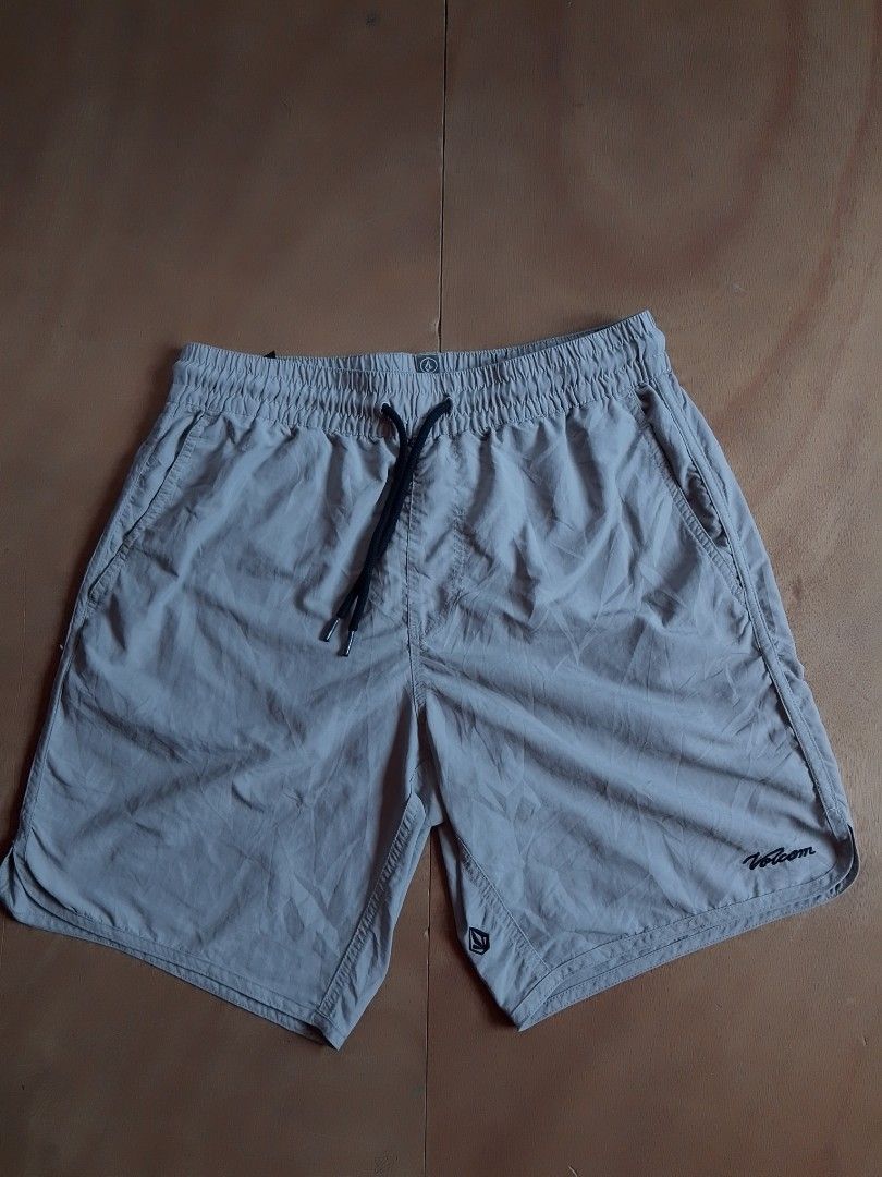 Volcom grey elastic drawstring surf shorts (Category: Shorts) located in Cebu City. Submitted by ranilcanoy89684 (Listing ID 1467166244, Image 2). Description: - Brand: Volcom - Color: Grey - Style: Lightweight surf shorts - Waistband: Elastic with black contrast drawstring - Pockets: Side pockets and one back pocket with branded patch - Branding: Volcom script logo on lower left leg and stone logo near hem - Ideal for: Beach days and casual wear