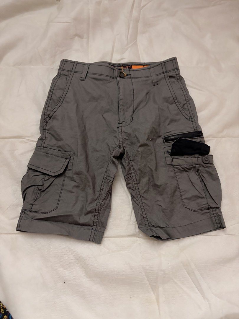 Wear First Cargo Shorts Grey Size 8 (Category: Shorts) located in Dasmarinas. Submitted by thriftcavite (Listing ID 1466986579, Image 1). Description: - Brand: Wear First - Size: Tagged Size 8 - Color: Grey with bright orange interior waistband lining - Material: 97% cotton, 3% spandex blend (slight stretch) - Storage: Multiple utility pockets with secure button and zipper details - Care: Machine washable - Condition: Durable everyday shorts, per