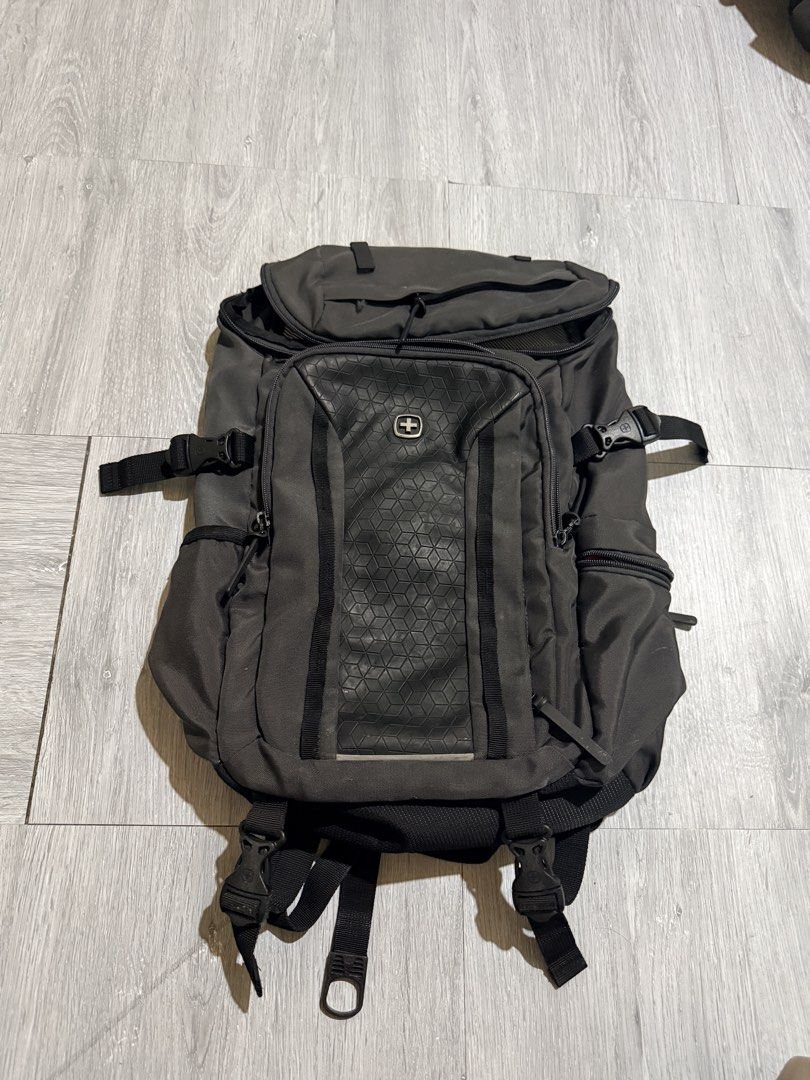 Wenger Airflow Backpack Grey (Category: Backpacks) located in Cavite. Submitted by aneps3 (Listing ID 1467097232, Image 1). Description: - Brand: Wenger - Color: Grey with unique hexagon textured front panel - Comfort: Airflow back padding system and adjustable shoulder straps - Storage: Multiple zipped compartments, side pockets, and internal mesh pocket - Safety: Built-in reflective stripe on straps - Condition: Clean interior with striped lini
