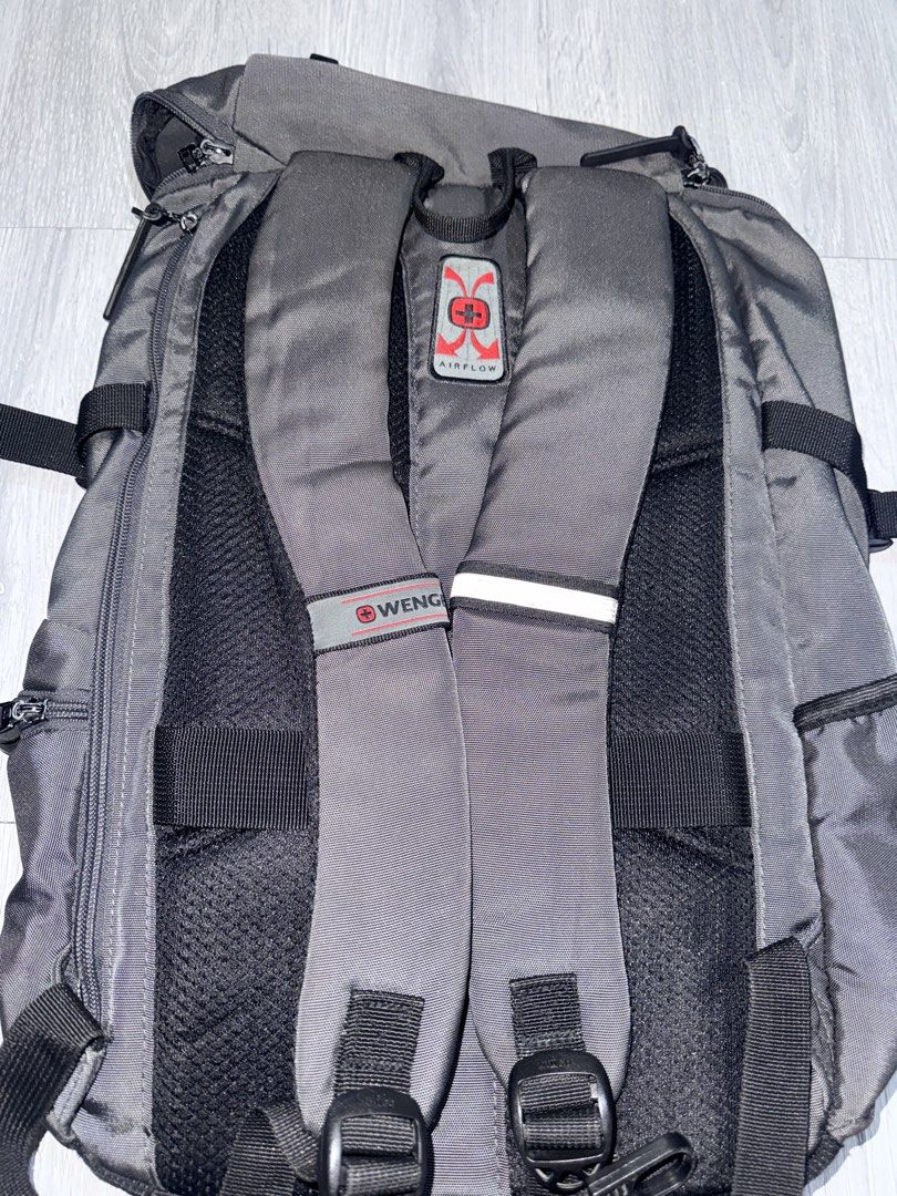 Wenger Airflow Backpack Grey (Category: Backpacks) located in Cavite. Submitted by aneps3 (Listing ID 1467097232, Image 3). Description: - Brand: Wenger - Color: Grey with unique hexagon textured front panel - Comfort: Airflow back padding system and adjustable shoulder straps - Storage: Multiple zipped compartments, side pockets, and internal mesh pocket - Safety: Built-in reflective stripe on straps - Condition: Clean interior with striped lini