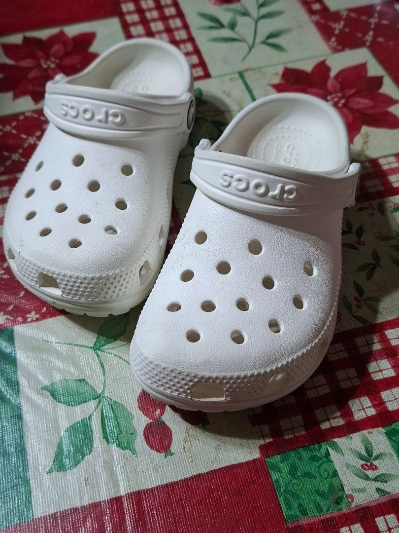 White Crocs Classic Clogs Size C11 (Category: Babies & Kids Fashion) located in Bulacan. Submitted by Krizzy_Things (Listing ID 1467076527, Image 1). Description: - Authentic White Classic Crocs Clogs - Size: C11 (marked on soles) - Iconic comfort cushioning for all-day wear - Breathable ventilation holes on top and sides - Secure pivoting heel strap with Crocs logo - Lightweight, water-friendly, and slip-on design - Textured outsoles for reliabl