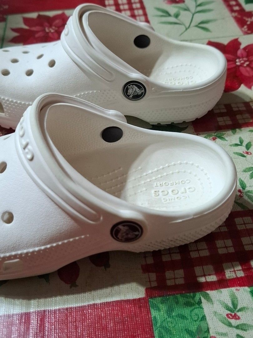 White Crocs Classic Clogs Size C11 (Category: Babies & Kids Fashion) located in Bulacan. Submitted by Krizzy_Things (Listing ID 1467076527, Image 2). Description: - Authentic White Classic Crocs Clogs - Size: C11 (marked on soles) - Iconic comfort cushioning for all-day wear - Breathable ventilation holes on top and sides - Secure pivoting heel strap with Crocs logo - Lightweight, water-friendly, and slip-on design - Textured outsoles for reliabl