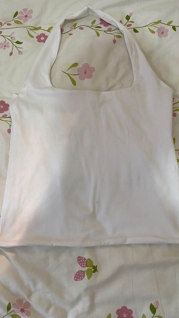 White halter neck top sleeveless square neckline (Category: Sleeveless) located in Caloocan City. Submitted by lianarchiveee (Listing ID 1467091879, Image 1). Description: - Style: Halter neck top with a chic square neckline - Design: Sleeveless, solid color, smooth fabric - Versatility: Easy to match with jeans or skirts - Occasion: Perfect for daily casual wear - Condition: Brand new / Excellent quality.