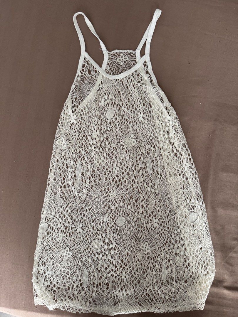 White Lace Tank Top Racerback (Category: Sleeveless) located in Manila. Submitted by maliwana.gan (Listing ID 1467032542, Image 1). Description: Fits S to M Loc: Tomas Morato, QC Lalamove c/o buyer - Color: White - Style: Racerback tank top with pullover design - Material: Lightweight open crochet knit lace - Features: Great for layering over swimwear or bralettes - Condition: Excellent, clean hems with zero stains or loose threads.