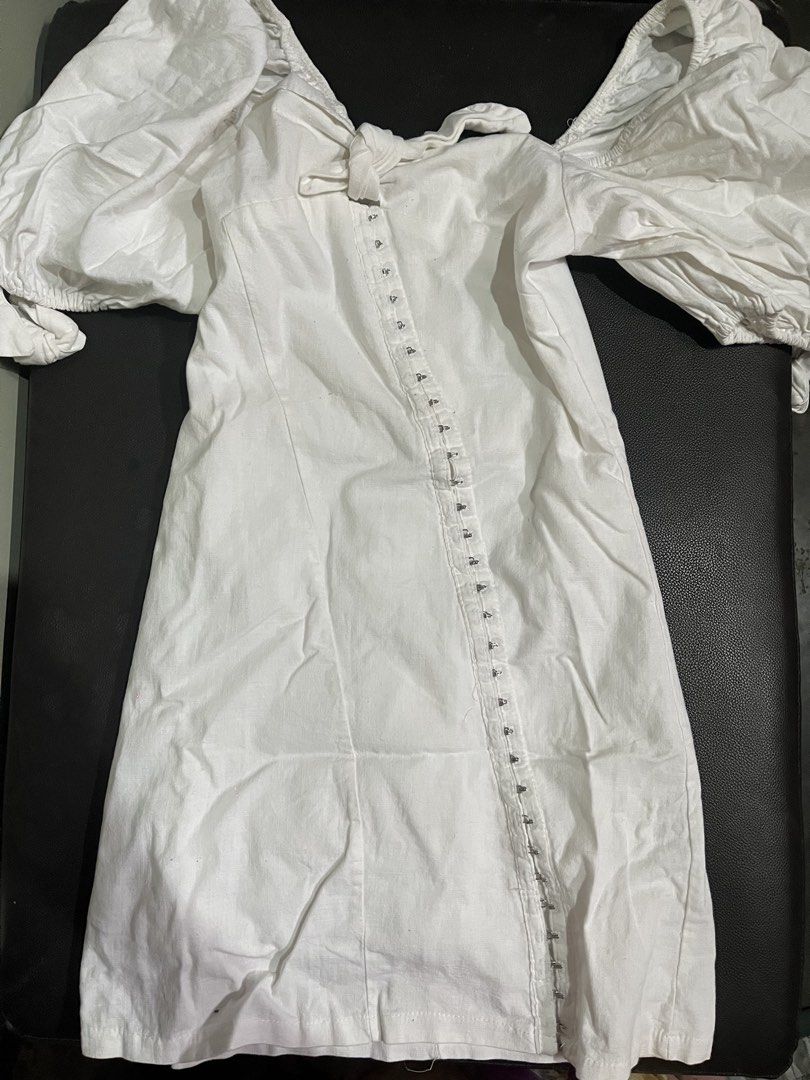 White off-shoulder puff sleeve mini dress (Category: Dresses) located in Manila. Submitted by rhiangastadora (Listing ID 1467036490, Image 1). Description: - Color: White - Style: Off-shoulder mini dress with a fitted bodycon silhouette - Details: Dramatic puff sleeves, sweetheart neckline with front tie, and asymmetrical diagonal hook-and-eye closure - Closure: Convenient back zipper - Ideal for: Resort wear, pool days, and outdoor brunch dates.