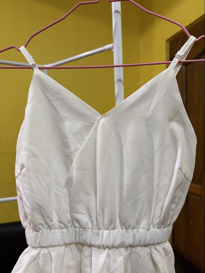 White Spaghetti Strap Tiered Maxi Dress (Category: Dresses) located in Calamba. Submitted by handpickedbynetty (Listing ID 1467125914, Image 2). Description: - Style: White sleeveless long dress with floor-length tiered ruffled skirt - Details: Adjustable spaghetti straps, V-neck wrap bodice, and elasticized waistline - Material: Lightweight and breathable, ideal for warm weather and casual events - Condition: Preloved from personal closet, smoke