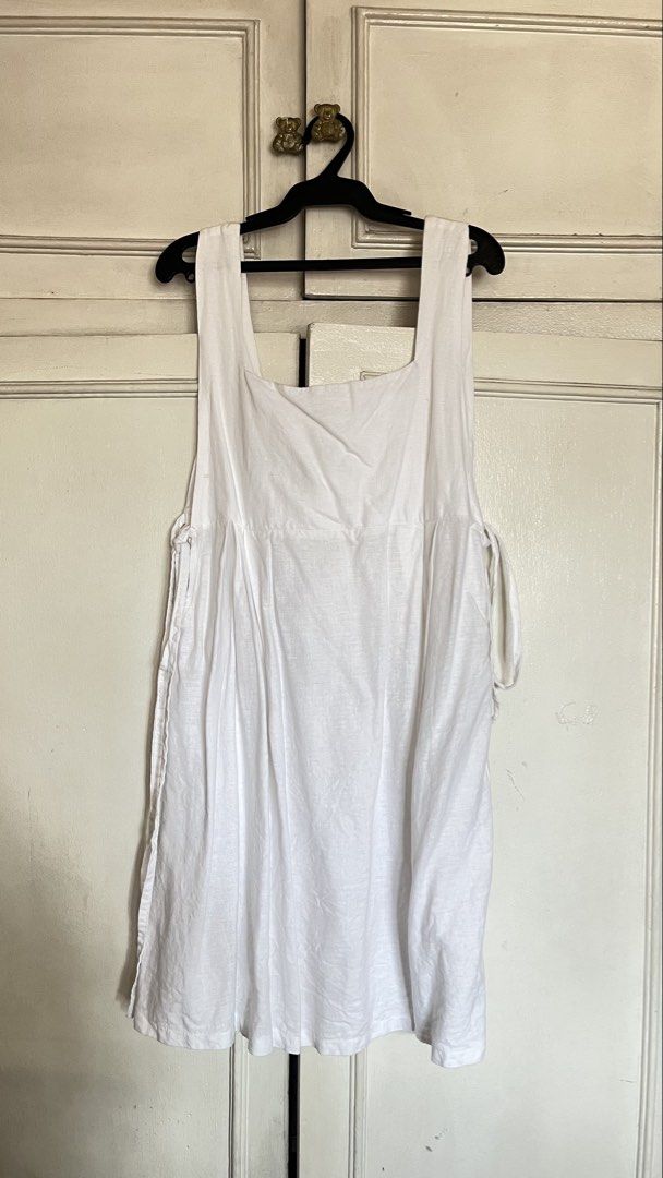 White Square Neck Sundress with Tie Sides (Category: Dresses) located in Quezon City. Submitted by jellycooties (Listing ID 1467005221, Image 1). Description: - Style: Minimalist white midi sundress - Neckline & Straps: Square neckline with wide straps - Fit: Gathered waist with adjustable side ties for a custom fit - Material: Lightweight, breathable cotton fabric - Silhouette: Flowy skirt - Occasion: Ideal for warm weather, casual days, and bea