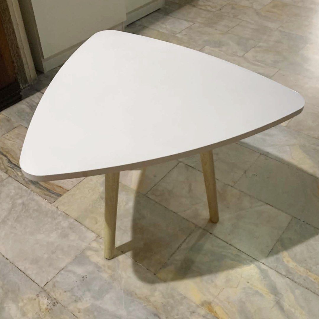White Triangular Coffee center side Table with Wooden Legs (Category: Tables & Sets) located in Marikina City. Submitted by lovegoeson (Listing ID 1467040729, Image 1). Description: - Style: Minimalist Nordic design with a chic white triangular top - Build: Supported by 3 sturdy wooden legs for secure placement - Size: Compact and space-saving, ideal as a side table for small living rooms or bedrooms - Condition: Has noticeable surface scratches 
