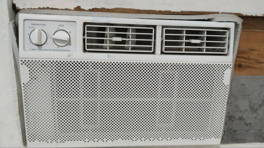 White Window Air Conditioner Unit with Dual Rotary Dials (NEGO) (Category: Air Conditioning and Heating) located in Manila. Submitted by curated.clutter12 (Listing ID 1467006933, Image 1). Description: - Type: Window air conditioner (NEGO) - Color: Standard white - Controls: Dual rotary dials for temperature and mode - Features: Perforated front grill with two adjustable horizontal air vents - Condition: Pulled from a working wall installation se