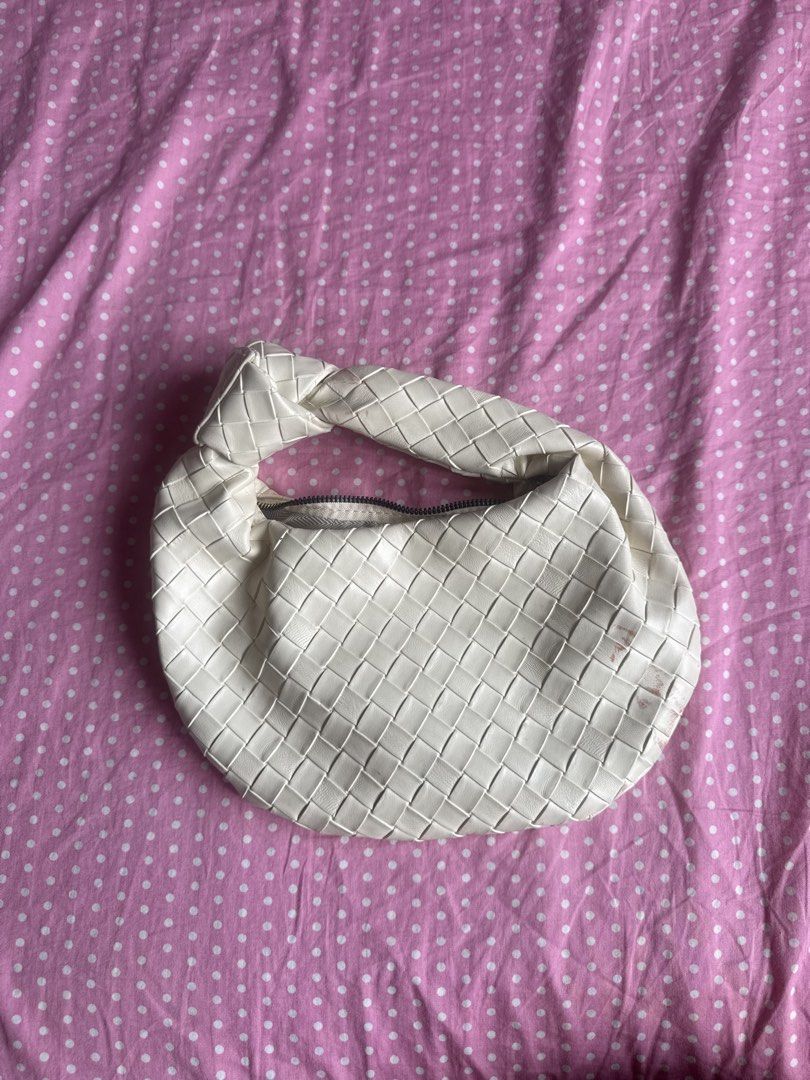 White Woven Knot Handle Shoulder Bag (Category: Shoulder Bags) located in Manila. Submitted by gkamille01 (Listing ID 1467011637, Image 1). Description: - Color & Style: White woven faux leather shoulder bag with an intrecciato pattern and trendy knotted top handle - Closure & Interior: Secure top zip closure with a spacious, fabric-lined interior - Size: Compact and practical, ideal for carrying your daily essentials - Condition: Noticeable pink