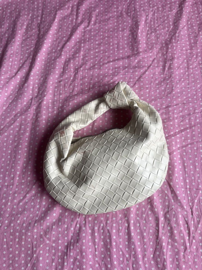 White Woven Knot Handle Shoulder Bag (Category: Shoulder Bags) located in Manila. Submitted by gkamille01 (Listing ID 1467011637, Image 3). Description: - Color & Style: White woven faux leather shoulder bag with an intrecciato pattern and trendy knotted top handle - Closure & Interior: Secure top zip closure with a spacious, fabric-lined interior - Size: Compact and practical, ideal for carrying your daily essentials - Condition: Noticeable pink
