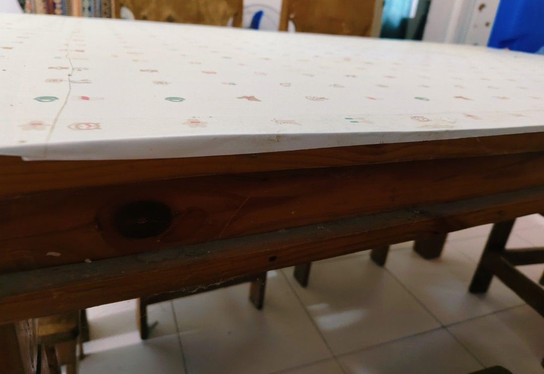 Wooden dining table set with six chairs (Category: Tables & Sets) located in Bulacan. Submitted by babz30261 (Listing ID 1467072508, Image 2). Description: - Solid wooden dining table with rich brown wood grain finish - Includes 6 matching chairs with tall cutout backs and solid wooden seats - Heavy and sturdy construction, great for families and gatherings - Table is currently protected by a patterned top cover - Shows normal signs of previous u