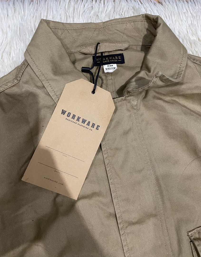Workware Heritage Clothing Co. Khaki Jacket Size Medium (Category: Coats, Jackets and Outerwear) located in Antipolo. Submitted by switchneighborhood (Listing ID 1467118056, Image 3). Description: - Brand: Workware Heritage Clothing Co. - Condition: Brand new with tag still attached - Size: Medium fits XL - Color: Khaki - Style: Utility jacket - Features: Two large front chest pockets, button closures, adjustable drawstring hem, and button detail