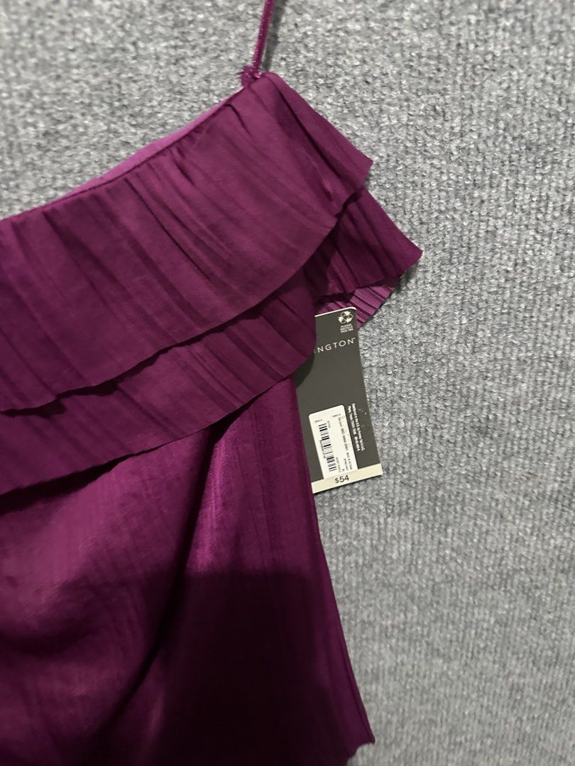 Worthington Purple One-Shoulder Ruffle Blouse (Category: Blouses) located in Villasis. Submitted by justinramosonfb (Listing ID 1467117461, Image 2). Description: - Brand: Worthington - Condition: Brand new with original tags attached - Size: XL - Color: Purple - Material: 100% polyester with subtle textured stripes - Design: One-shoulder with thin spaghetti strap and multi-tiered front ruffle overlay - Care: Machine washable in cold water.