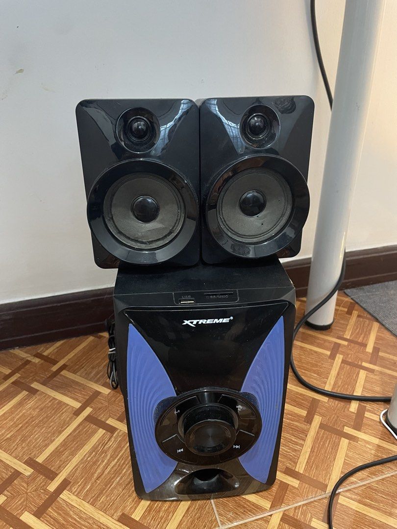 Xtreme XP-2 Speaker System (Category: Soundbars, Speakers & Amplifiers) located in Manila. Submitted by ch1lleroli82692 (Listing ID 1467027672, Image 1). Description: - Model: Xtreme XP-2 speaker system - Includes: 1 subwoofer and 2 satellite speakers - Color: Black with stylish blue side accents - Controls: Side and back panel rotary knobs for volume, echo, and bass - Connectivity: USB port and SD card slot on the top front panel - Inclusions: C