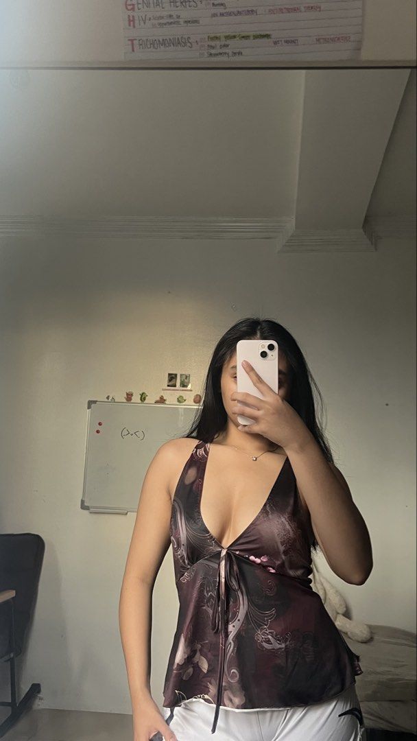 Y2K Floral Halter Top Brown Satin (Category: Sleeveless) located in Manila. Submitted by iayo.15 (Listing ID 1467071057, Image 1). Description: - Style: Dark brown halter top with pink floral print - Fit: Deep V-neckline with adjustable center tie string - Material: Silky, smooth fabric with a nice drape - Styling: Pairs effortlessly with white shorts - Condition: Worn a few times, still in solid shape.