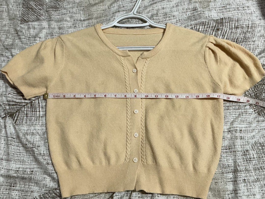 Yellow Cardigan (Category: Blouses) located in Quezon City. Submitted by cleaningmomma (Listing ID 1467064253, Image 2). Description: - Color: Peach cream - Style: Knit cardigan with short puff sleeves and round neckline - Details: Textured front button placket, ribbed hem and cuffs - Material: Soft textured knit fabric - Measurements: ~17.5" chest width, ~17" total length - Condition: Brand new / Excellent (Ready to wear) - Styling: Great with h