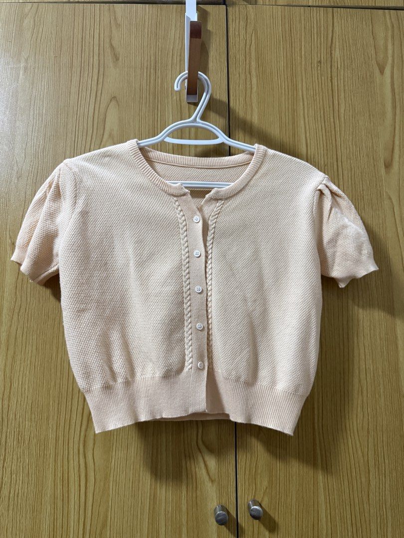Yellow Cardigan (Category: Blouses) located in Quezon City. Submitted by cleaningmomma (Listing ID 1467064253, Image 1). Description: - Color: Peach cream - Style: Knit cardigan with short puff sleeves and round neckline - Details: Textured front button placket, ribbed hem and cuffs - Material: Soft textured knit fabric - Measurements: ~17.5" chest width, ~17" total length - Condition: Brand new / Excellent (Ready to wear) - Styling: Great with h