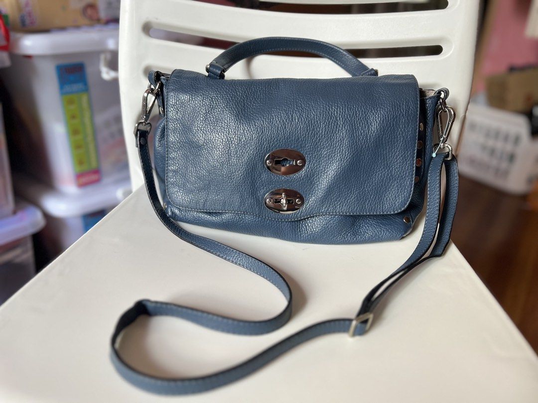 Zanellato Postina Small in Blue Pebbled Leather (Category: Luxury Bags & Wallets) located in Quezon City. Submitted by kaye_mm (Listing ID 1467101952, Image 2). Description: • Authenticity: 100% Authentic/ Original • Material: 100% grained/hammered calfskin leather exterior; 100% cotton lining interior • Color: Blue • Dimensions (Small): Approximately 29 cm x 20 cm x 15 cm • Features: Flap top with a twist-lock fastening, metal stud accents, sing
