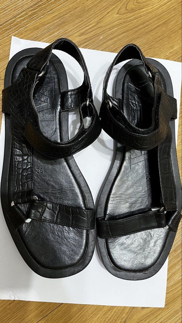 Zara Black Crocodile Embossed Flat Sandals Size 36 (Category: Flats & Sandals) located in Pasig City. Submitted by ___she___ (Listing ID 1467126670, Image 1). Description: - Brand: Zara - Style: Flat sandals - Color: Black - Size: EU 36 - Details: Crocodile-embossed front and heel straps, metal ring hardware, and large embossed Zara logo on the footbed - Closure: Velcro ankle strap - Sole: Flat rubber sole - Condition: Worn a few times, with mino