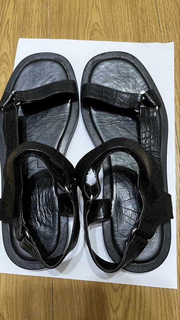 Zara Black Crocodile Embossed Flat Sandals Size 36 (Category: Flats & Sandals) located in Pasig City. Submitted by ___she___ (Listing ID 1467126670, Image 2). Description: - Brand: Zara - Style: Flat sandals - Color: Black - Size: EU 36 - Details: Crocodile-embossed front and heel straps, metal ring hardware, and large embossed Zara logo on the footbed - Closure: Velcro ankle strap - Sole: Flat rubber sole - Condition: Worn a few times, with mino