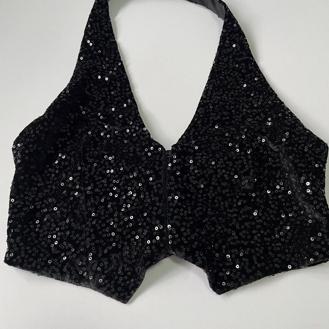 Zara Black Sequin Halter Crop Top (Category: Sleeveless) located in Pasay City. Submitted by lovedbyzea (Listing ID 1467051379, Image 3). Description: - Color: Sparkly black with tiny sequins - Material: Soft velvet-feel fabric underneath - Design: Halter neck, V-cut, front hook-and-eye fastening, open back, and stylish pointed hem - Vibe: Dark, moody, and edgy - Perfect for: Night outs, parties, clubbing, and concerts.