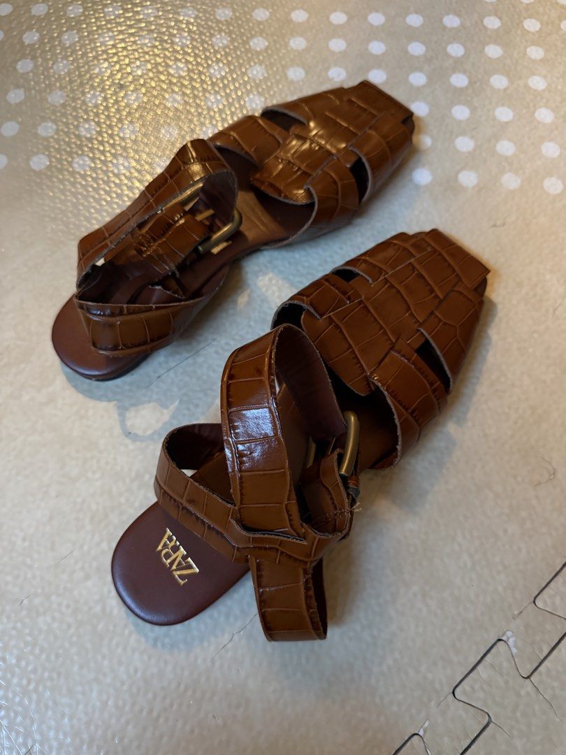 Zara Brown Crocodile Embossed Flat Sandals Size 37 (Category: Flats & Sandals) located in Makati City. Submitted by katvtorre (Listing ID 1467034821, Image 2). Description: - Brand: Zara - Style: Brown sandals with trendy crocodile embossed texture and glossy finish - Size: 37 (marked on sole) - Design: Chic square toe, flat heel, and secure chunky ankle strap with buckle closure - Condition: Worn twice, with minimal wear on the bottom soles - Ma