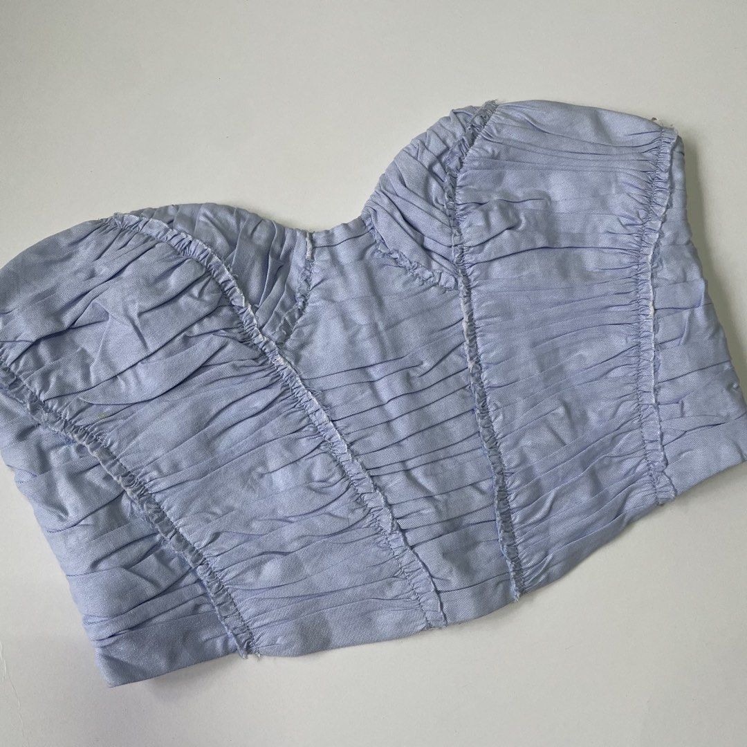 Zara Light Blue Strapless Ruched Corset (Category: Sleeveless) located in Pasay City. Submitted by lovedbyzea (Listing ID 1467043422, Image 2). Description: - NEEDS WASH! (with dot yellow stains from storage) - Color: Light blue with white contrast lining - Style: Strapless cropped corset top with heavy ruching - Details: Structured sweetheart neckline with boning channels, hook-and-eye closure at center back - Fit: Cropped length, pairs great wi
