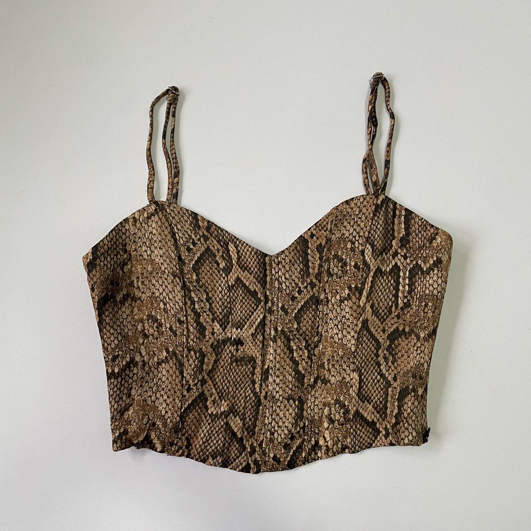 Zara Snake Print Corset Top (Category: Sleeveless) located in Pasay City. Submitted by lovedbyzea (Listing ID 1467041075, Image 1). Description: - Brown and black snakeskin print corset crop top - Sweetheart neckline with thin adjustable spaghetti straps - Structured boning down the front bodice - Secure side zipper closure with smooth black lining - Great going-out piece, easily pairs with high-waisted jeans or skirts.
