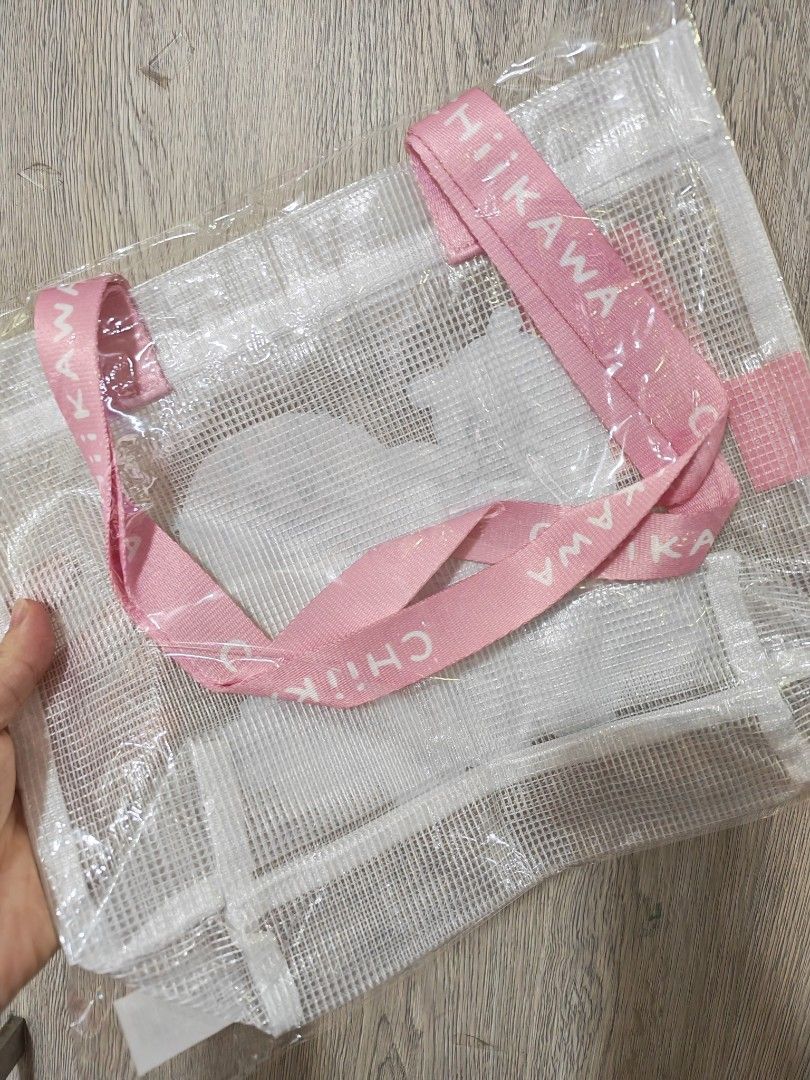 2 Chiikawa Clear Mesh Tote Bags (Category: Tote Bags) located in Manila. Submitted by declutter_sarah (Listing ID 1467321081, Image 2). Description: - Authentic Chiikawa clear mesh tote bag with cute character prints - Brand new, sealed in original plastic packaging - Features stylish branded straps reading "CHIIKAWA" - Two handle color options available: Pink or Yellow - Spacious and sturdy, perfect for daily essentials or convention shopping.