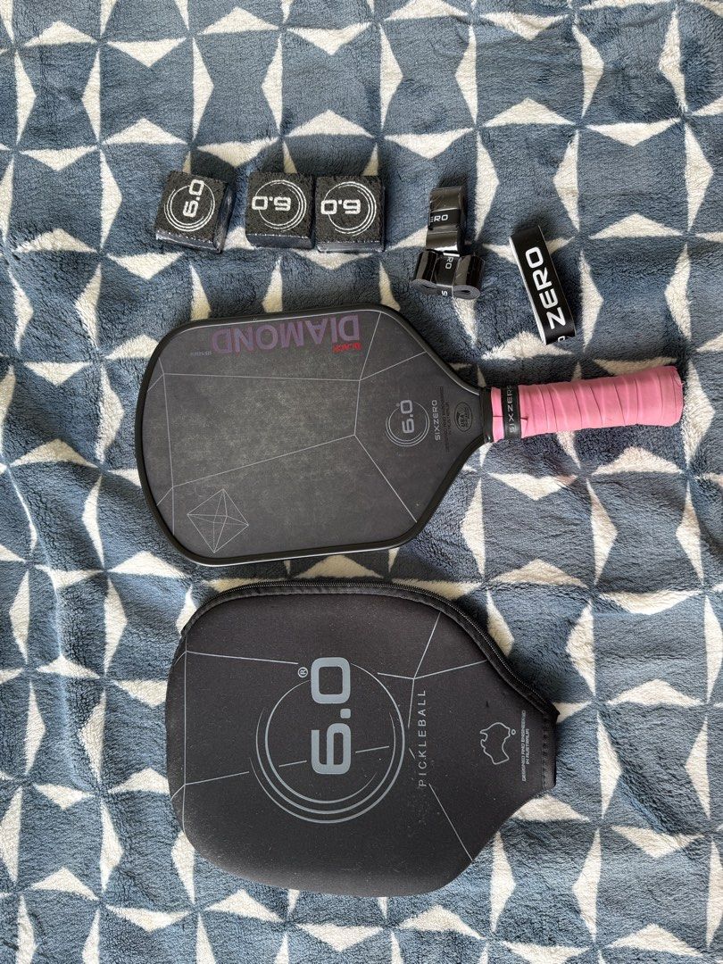 6.0 Six Zero Black Diamond Pickleball Paddle Set (Category: Racket and Ball Sports) located in Lapu Lapu. Submitted by andrewalst84649 (Listing ID 1467209304, Image 1). Description: - Item: Six Zero Black Diamond Pickleball Paddle - Color: Black with pink overgrip - Surface: Textured face for enhanced spin - Inclusions: Original protective cover, 3x Six Zero erasers for maintenance, extra overgrip rolls, and a Six Zero - Condition: Complete set, 