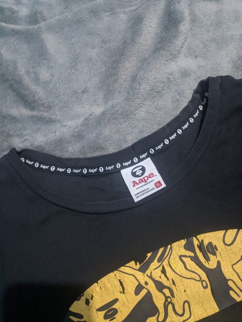 Aape By A Bathing Ape Black Graphic Tee (Category: Shirts) located in San Ildefonso. Submitted by tripniberto (Listing ID 1467309355, Image 2). Description: AAPE Dimes:17W/24L Issue: Need wash, Hairline/Crack prints, Sign of use Color Rate: 8.7/10(or better) (lighting may affect the color on images) MOP: gcash MOD: j&t(+sf) NO RUSH SHIPPING!!! (3-5days Ship out!) please manage your expectations this is ukay items PM if interested 📩 Bulacan 📍.