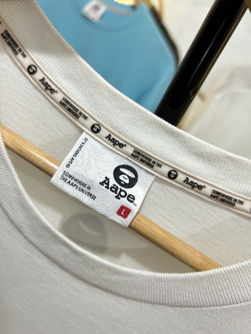 AAPE by A Bathing Ape White Patch T-Shirt (Category: Tshirts & Polo Shirts ) located in Manila. Submitted by cachegoodsuncovers (Listing ID 1467287371, Image 3). Description: Condition:Exellent close to brandnew Color rate:9.5/10 Size:L Dimes:23x30 Issue:none .