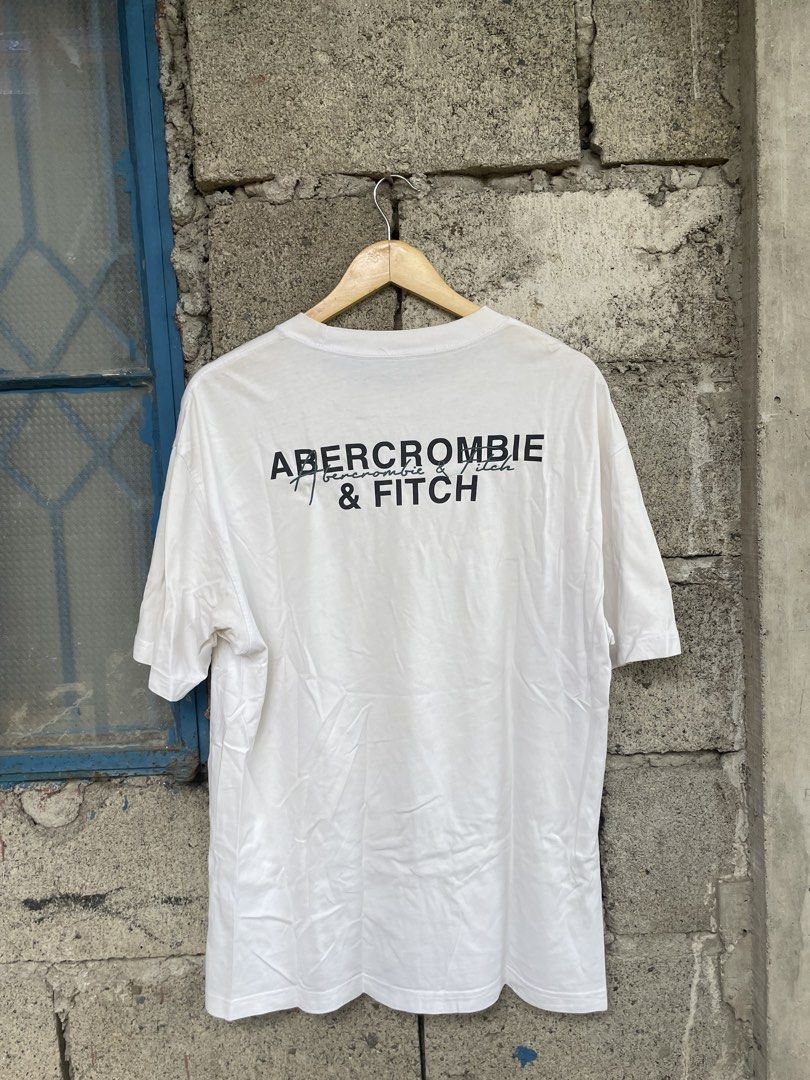 Abercrombie & Fitch Oversized Soft A&F Tee White Medium (Category: Tshirts & Polo Shirts ) located in Dagupan City. Submitted by thriftykiddo.ph (Listing ID 1467227481, Image 2). Description: - Brand: Abercrombie & Fitch - Color: White - Size: Medium (Oversized fit) - Material: Soft A&F signature tee fabric - Details: Small embroidered script logo on left chest, large bold block lettering graphic print on the back - Neckline/Sleeves: Crew necklin