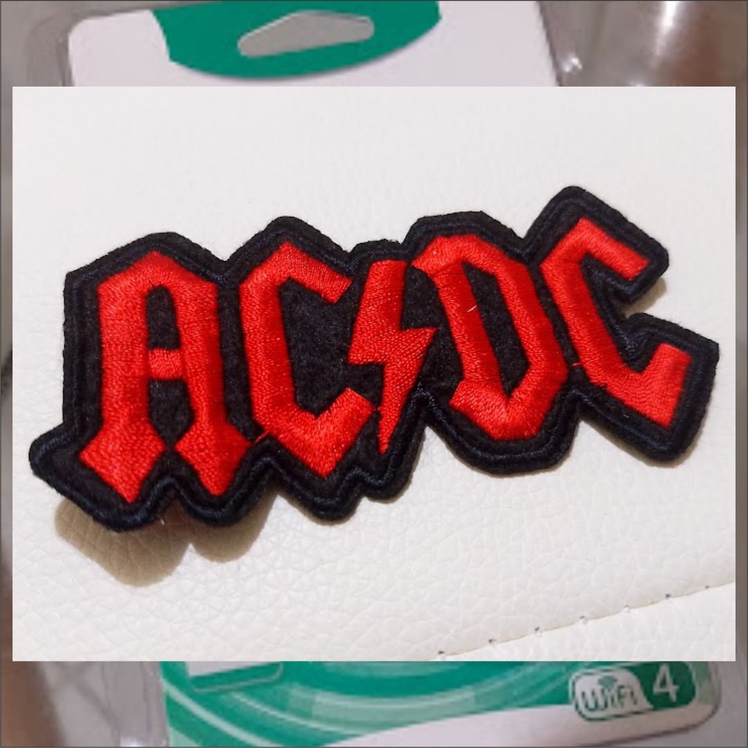 AC/DC Embroidered Logo Patch (Category: Caps & Hats) located in Quezon City. Submitted by susmaryosep1 (Listing ID 1467270132, Image 2). Description: - Item: AC/DC rock band logo patch - Design: Classic red embroidered letters with black border and lightning bolt - Condition: Brand new, unused, clean edges - Application: Iron-on backing for easy attachment - Best for: Denim jackets, vests, backpacks, and bags 200 pesos.