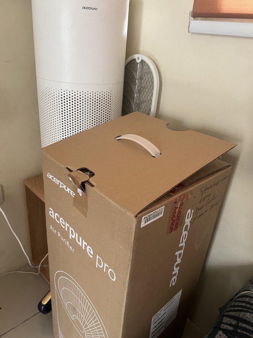 Acerpure Pro Air Purifier (Category: Air Purifiers & Dehumidifiers) located in General Trias. Submitted by lantiskumeo_9302 (Listing ID 1467189752, Image 1). Description: - Model: Acerpure Pro Air Purifier - Color: White, cylindrical design with perforated lower grille - Condition: Includes original brown cardboard box with handle and branding - Features: Keeps indoor air clean and fresh, operates quietly and efficiently - Setup: Simple plug-and-