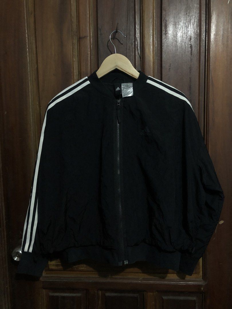 Adidas Black Track Jacket with White Stripes Size M (Category: Coats, Jackets and Outerwear) located in Quezon City. Submitted by yeahsource222 (Listing ID 1467241427, Image 1). Description: - Authentic Adidas black track jacket with iconic white three stripes - Full zip closure with a stylish stand-up collar - Material: 100% nylon with a comfortable recycled polyester lining - Ribbed cuffs and hem for a secure fit - Clean athletic look, perfect 