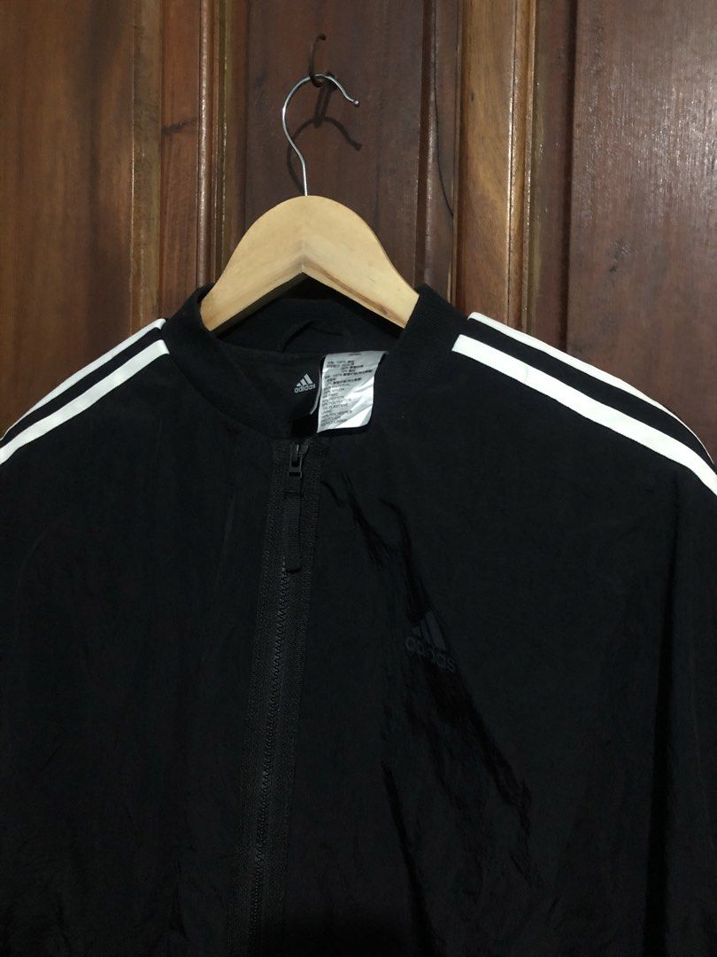 Adidas Black Track Jacket with White Stripes Size M (Category: Coats, Jackets and Outerwear) located in Quezon City. Submitted by yeahsource222 (Listing ID 1467241427, Image 2). Description: - Authentic Adidas black track jacket with iconic white three stripes - Full zip closure with a stylish stand-up collar - Material: 100% nylon with a comfortable recycled polyester lining - Ribbed cuffs and hem for a secure fit - Clean athletic look, perfect 