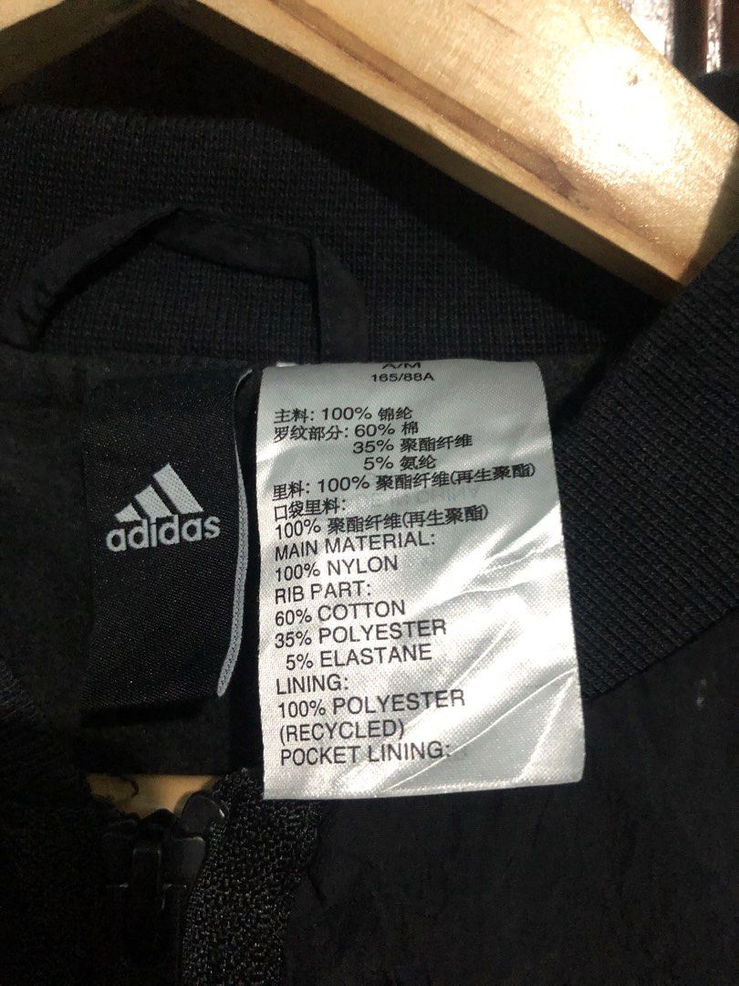 Adidas Black Track Jacket with White Stripes Size M (Category: Coats, Jackets and Outerwear) located in Quezon City. Submitted by yeahsource222 (Listing ID 1467241427, Image 3). Description: - Authentic Adidas black track jacket with iconic white three stripes - Full zip closure with a stylish stand-up collar - Material: 100% nylon with a comfortable recycled polyester lining - Ribbed cuffs and hem for a secure fit - Clean athletic look, perfect 