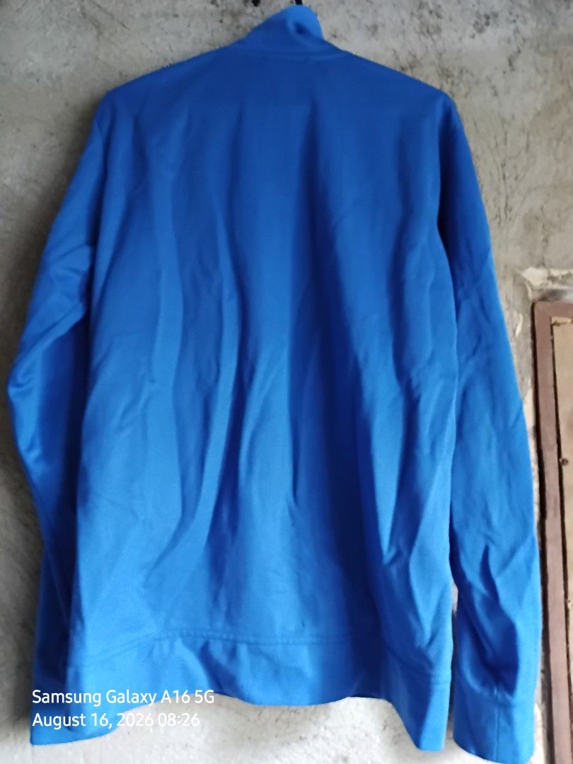 Adidas Blue Zip-up Jacket Size 105 (Category: Coats, Jackets and Outerwear) located in Manila. Submitted by thomyorke14 (Listing ID 1467249830, Image 2). Description: - Brand: Adidas - Color: Bright blue - Size: 105 (Made in Indonesia) - Style: Zip-up jacket with high neck collar and full zipper closure Dimes 20 by 27 - Details: Ribbed inner lining near the collar, classic trefoil logo branding - Condition/Use: Comfortable fabric, perfect for eve