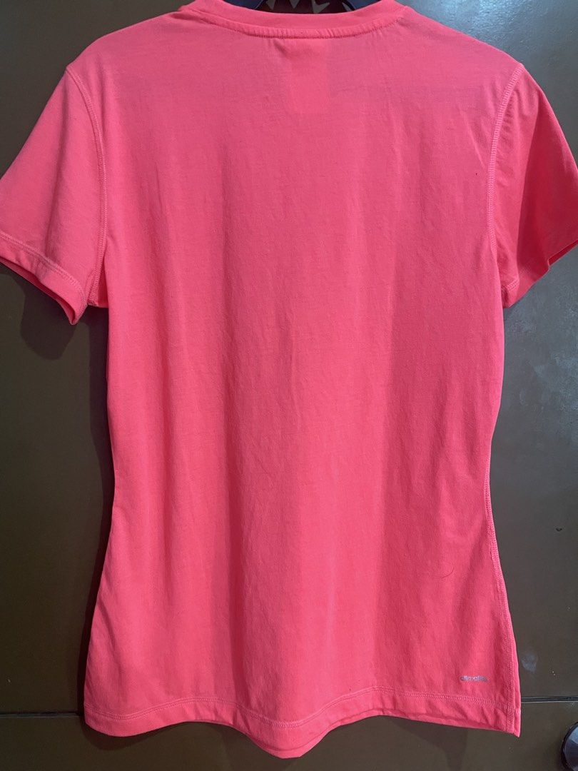 Adidas Climalite Pink Active T-Shirt (Category: Shirts) located in Manila. Submitted by mochi_dear (Listing ID 1467211957, Image 2). Description: - Brand: Adidas - Style: Active t-shirt with crew neck and short sleeves - Color: Bright pink with small silver chest logo - Size: Women's Small - Technology: Climalite branding near bottom hem for breathability - Condition: Clean, soft fabric, tag intact inside collar - Ideal for: Gym workouts, running