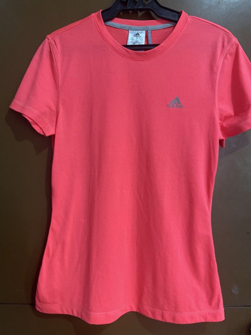 Adidas Climalite Pink Active T-Shirt (Category: Shirts) located in Manila. Submitted by mochi_dear (Listing ID 1467211957, Image 1). Description: - Brand: Adidas - Style: Active t-shirt with crew neck and short sleeves - Color: Bright pink with small silver chest logo - Size: Women's Small - Technology: Climalite branding near bottom hem for breathability - Condition: Clean, soft fabric, tag intact inside collar - Ideal for: Gym workouts, running