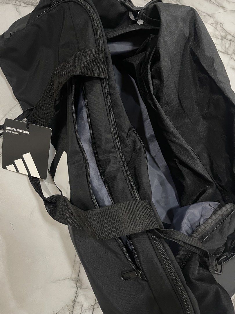Adidas Defender 3 Large Duffel Bag Black (Category: Sling Bags) located in San Jose del Monte. Submitted by xdy12 (Listing ID 1467217751, Image 2). Description: - Brand new with original store tags attached - Authentic Adidas Defender 3 large duffel bag in classic black - Features a large white Adidas logo on the side - Spacious main compartment with secure zipper closure - Convenient front zippered pocket for quick-access items - Adjustable shou