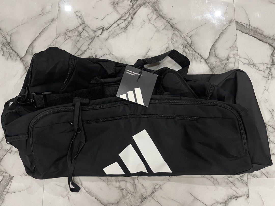 Adidas Defender 3 Large Duffel Bag Black (Category: Sling Bags) located in San Jose del Monte. Submitted by xdy12 (Listing ID 1467217751, Image 1). Description: - Brand new with original store tags attached - Authentic Adidas Defender 3 large duffel bag in classic black - Features a large white Adidas logo on the side - Spacious main compartment with secure zipper closure - Convenient front zippered pocket for quick-access items - Adjustable shou