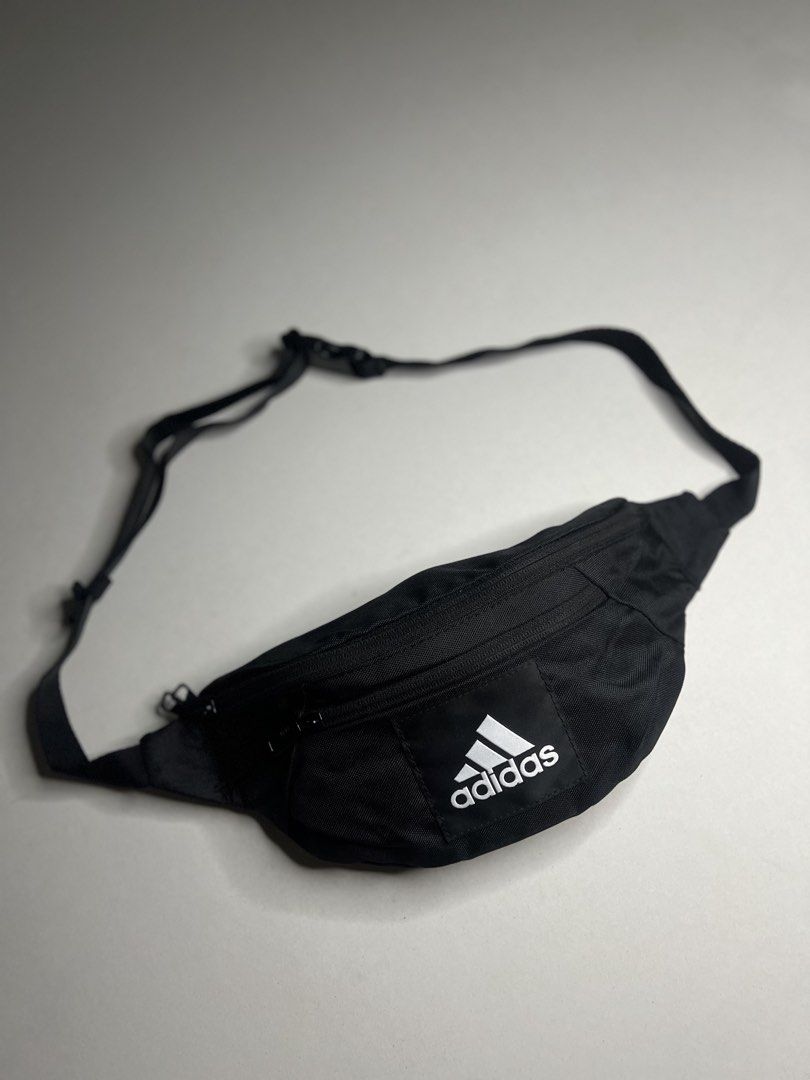Adidas ESS Waist Bag Black (Category: Belt bags, Clutches and Pouches) located in Tacloban City. Submitted by thrftg (Listing ID 1467279772, Image 1). Description: - Authentic Adidas waist bag in classic black - Bold white Adidas logo patch on the front - Durable fabric built for everyday wear - Features a secure main compartment and handy front zip pocket - Adjustable strap with sturdy buckle closure - Ideal for daily errands, traveling, or gym 