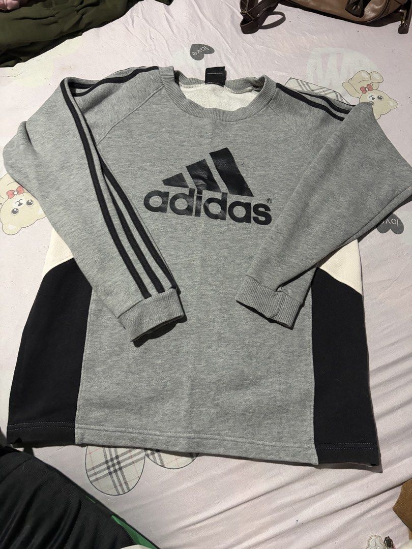 Adidas Grey Black Sweatshirt Size 10-12 / 152 (Category: Coats, Jackets and Outerwear) located in Manila. Submitted by mcllts (Listing ID 1467344147, Image 1). Description: - Brand: Adidas - Color: Grey with black and white side panels - Size: 10-12 years / 152 cm - Design: Classic crewneck, iconic front logo, and 3-stripes detailing on sleeves - Features: Ribbed cuffs and hem, made in China - Condition: Comfortably stylish casual wear for cooler